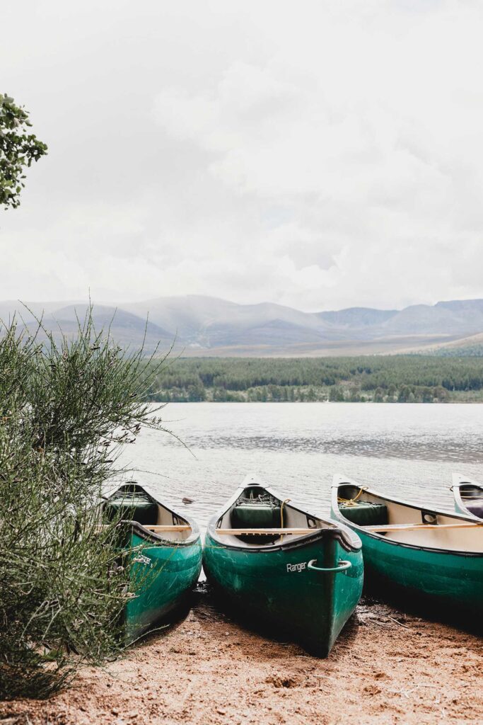 Boats on a lake with mountains in the background. The importance of nature in teaching us.