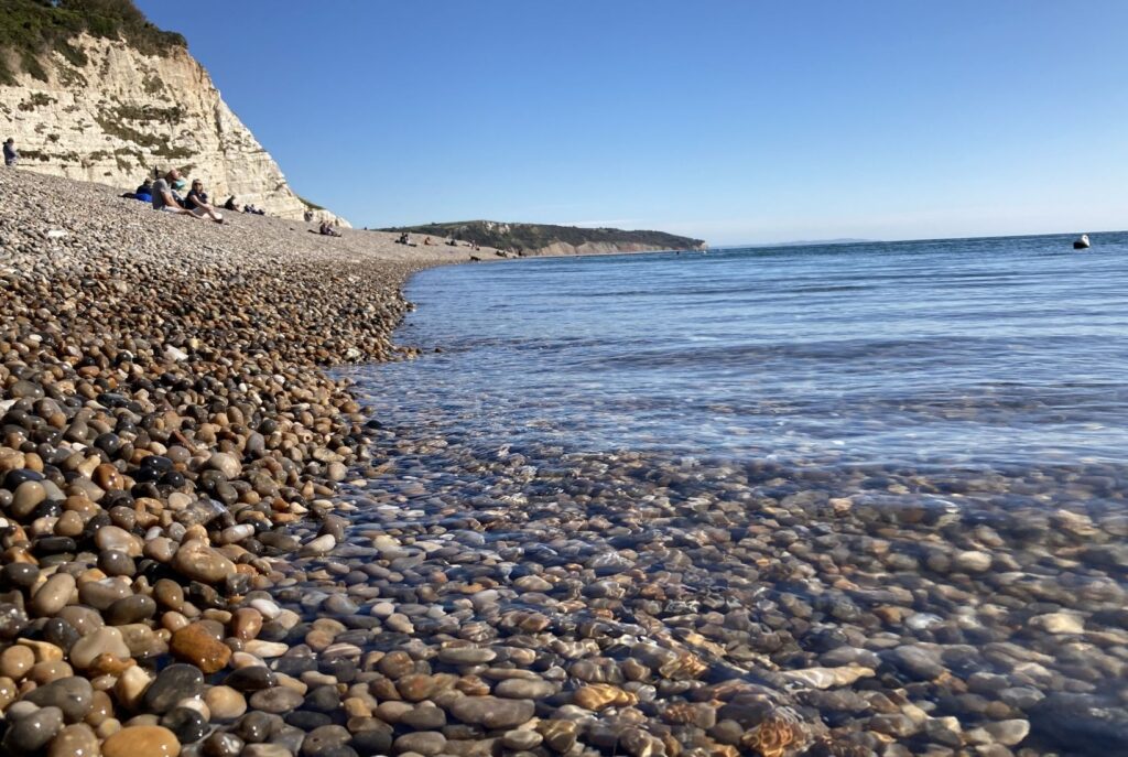 A pebble beach with crystal clear sea